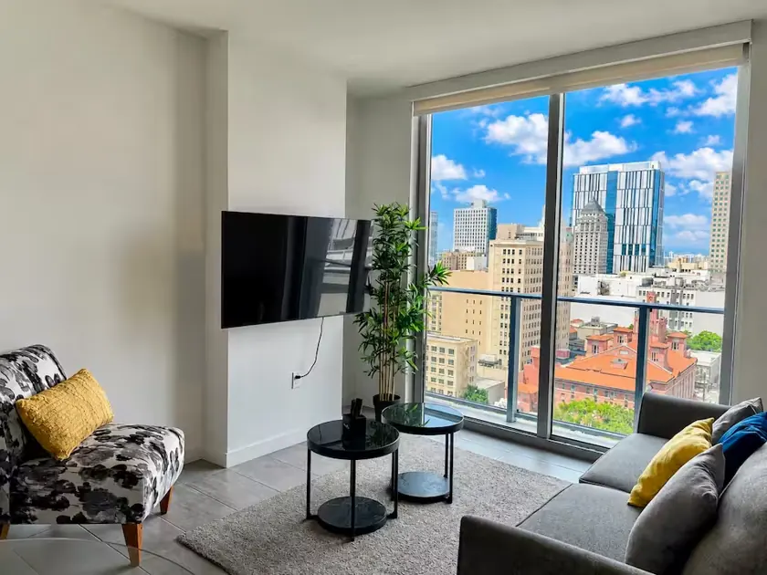 Living room with large windows and city views in apartment 1704