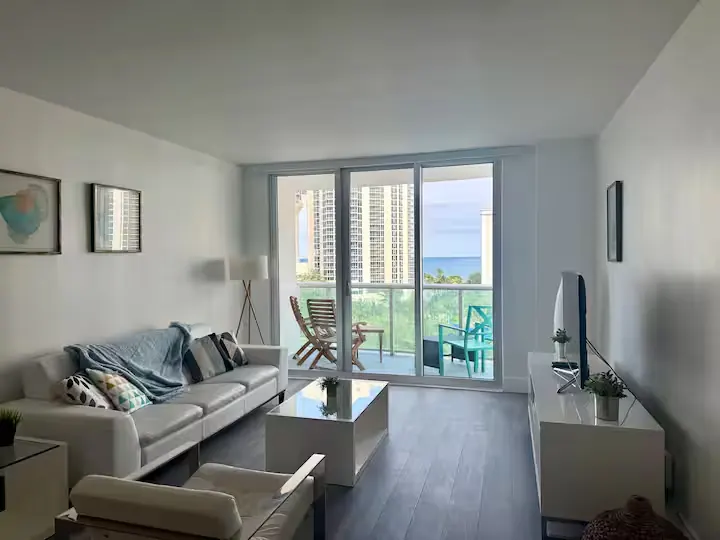 Sunny Isles Beach apartment 801 living room and ocean-view balcony